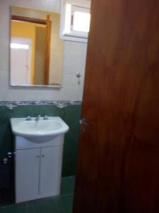 a bathroom with a sink and a mirror at CASA BALCARCE in Balcarce +10 photos