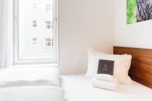 Postel nebo postele na pokoji v ubytování Smarthotel Tromsø