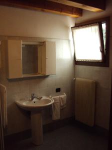 baño con lavabo, espejo y ventana en Agriturismo Sant' Anna en Treviso