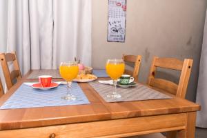 una mesa de madera con 2 vasos de zumo de naranja en You and Me -750m from the sea en Kissamos