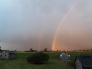 a double rainbow in the sky over a field at La Posada del Colono in Puerto Clocker