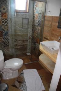 a bathroom with a toilet and a sink and a shower at Maria Teresa Bragança Pousada in Jericoacoara