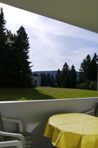 a yellow table and chairs on a balcony with a window at Fewo SH4 in Goslar