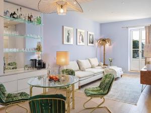 a living room with a couch and a table and chairs at Maison Panthère - Luxury Harbour Residence in Saint-Tropez