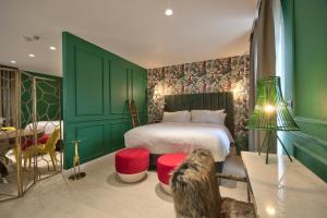 a bedroom with a bed and a dog sitting on a table at HOLM Boutique & SPA - IK Collection in St. Julianʼs