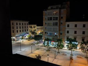 a view of a city at night with buildings at Piazza Duomo Deluxe in Cecina