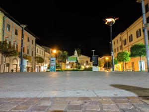 an empty street at night in a city at Piazza Duomo Deluxe in Cecina
