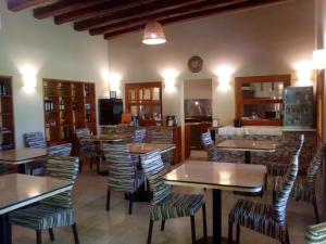 a living room filled with tables and chairs at Posada Cavieres Wine Farm in Maipú