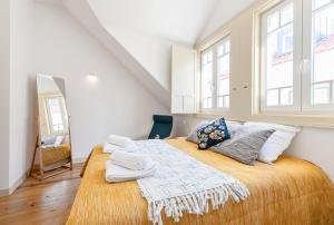 a bedroom with a large bed with a large window at Casa do Sapalinho II - Setubal Downtown in Setúbal