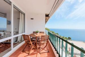 a balcony with a table and chairs and the ocean at Casa Bela Vista in Sesimbra