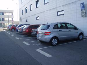 a row of cars parked in a parking lot at Ramada Airport Hotel Prague in Prague