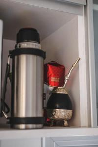 a coffee pot sitting on top of a shelf at Departamento amplio, nuevo y céntrico in Posadas