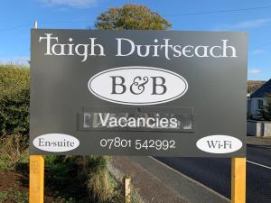 a sign for a british durhamnsicsnsics at Taigh Duitseach in Portree