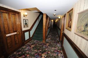 a hallway with a staircase with a flower carpet at Saddleback Inn at Lake Arrowhead in Lake Arrowhead