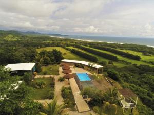 a house with a view of the ocean and mountains at La Colina Pura Vista in Bejuco