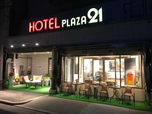 a hotel plaza with tables and chairs in the window at ビジネスインホテルプラザ21大阪京橋 in Osaka +43 photos
