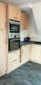 a kitchen with wooden cabinets and an oven at Bei Oparius wohlfühlen in Rethorn