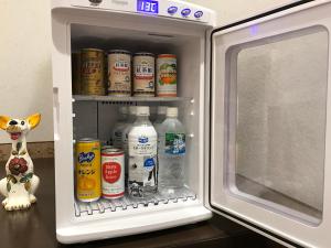 an open refrigerator filled with bottles of milk at ビジネスインホテルプラザ21大阪京橋 in Osaka