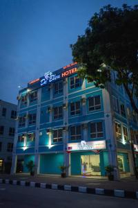 a blue hotel with a sign on top of it at Langkawi De Bleu Hotel in Kuah