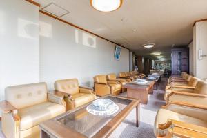 a row of chairs and tables in a waiting room at Tsuruga Tunnel Onsen Kitaguni Grand Hotel in Tsuruga