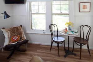 a room with a table and chairs and a window at Bird House in Kyneton