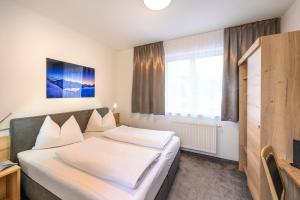 Łóżko lub łóżka w pokoju w obiekcie Appartements Insieme