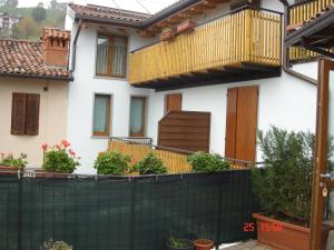 a house with a balcony and a fence at Bar Trattoria Colombina Affittacamere in Bossico