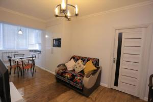 a living room with a couch and a dining room at Newly Renovated Modern 2 Bed Apt Near Gur-e-Amir -Brown Door in Samarkand