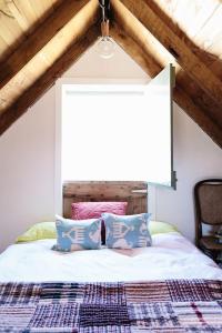 a bed with two pillows and a window in a room at Harpsichord House in Kyneton