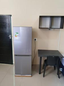 a refrigerator and a table in a room at Oasis Residence in Durban +10 photos