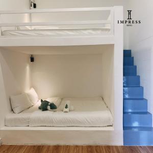 Postel nebo postele na pokoji v ubytování IMPRESS HOTEL
