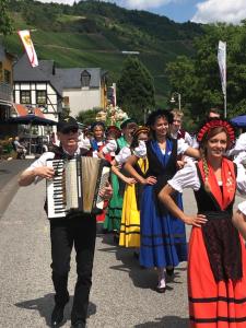 a group of people walking down a street with an accordion at Hotel Echternacher Hof in Kröv