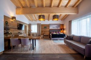 a living room with a couch and a table at Hotel Alpennest in Leutasch