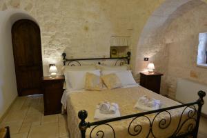 Postel nebo postele na pokoji v ubytování I Trulli Del Nonno Michele + 37 fotografií