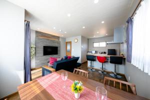 a living room and a dining room with a table at 21 ORIYA Mt Fuji -縁ENISHI- in Fujikawaguchiko