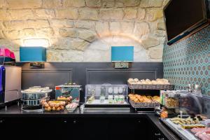 a bakery with a counter with different types of food at Monceau Elysées in Paris