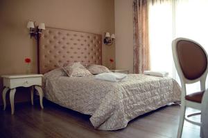 a bedroom with a bed and a table and a window at Astral Apartments in Chrysi Ammoudia