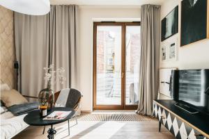 un soggiorno con divano e TV di Wawel Apartments by LoftAffair a Cracovia