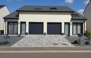 a rendering of a house with three garage doors at Le Cottage de Vany in Vany