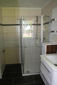 a bathroom with a shower and a sink at Ferienwohnung 1010 mit Seeblick in Ziemitz