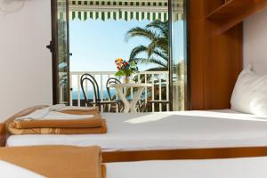 a bedroom with a bed and a view of the ocean at Apartments Marinko in Promajna