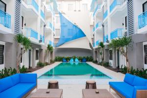 a swimming pool in the middle of a building at Bloo Bali Hotel in Legian