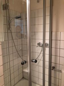 a shower with a glass door in a bathroom at Altstadt Kurzestr in Düsseldorf +47 photos