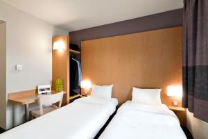 Postel nebo postele na pokoji v ubytování B&B HOTEL Lyon Sud États-Unis