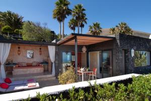 a house with a living room and a patio at Nirvana Lanzarote in La Asomada