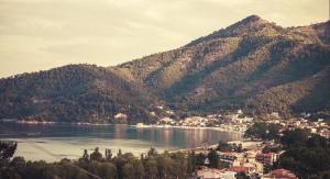 a large body of water with a town and mountains at Astral Apartments in Chrysi Ammoudia