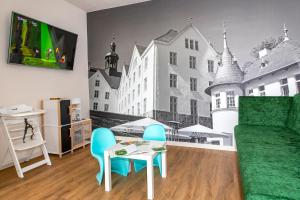 a living room with a couch and a table with chairs at Lake House Plön in Plön