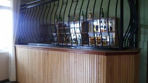 a bunch of wine bottles sitting on top of a shelf at Westcliff Hotel in Lira