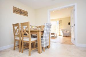 a kitchen and dining room with a table and chairs at The Parlour , Emsworth in Emsworth