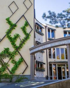 a building with ivy on the side of it at Green Palace Hotel in Yerevan